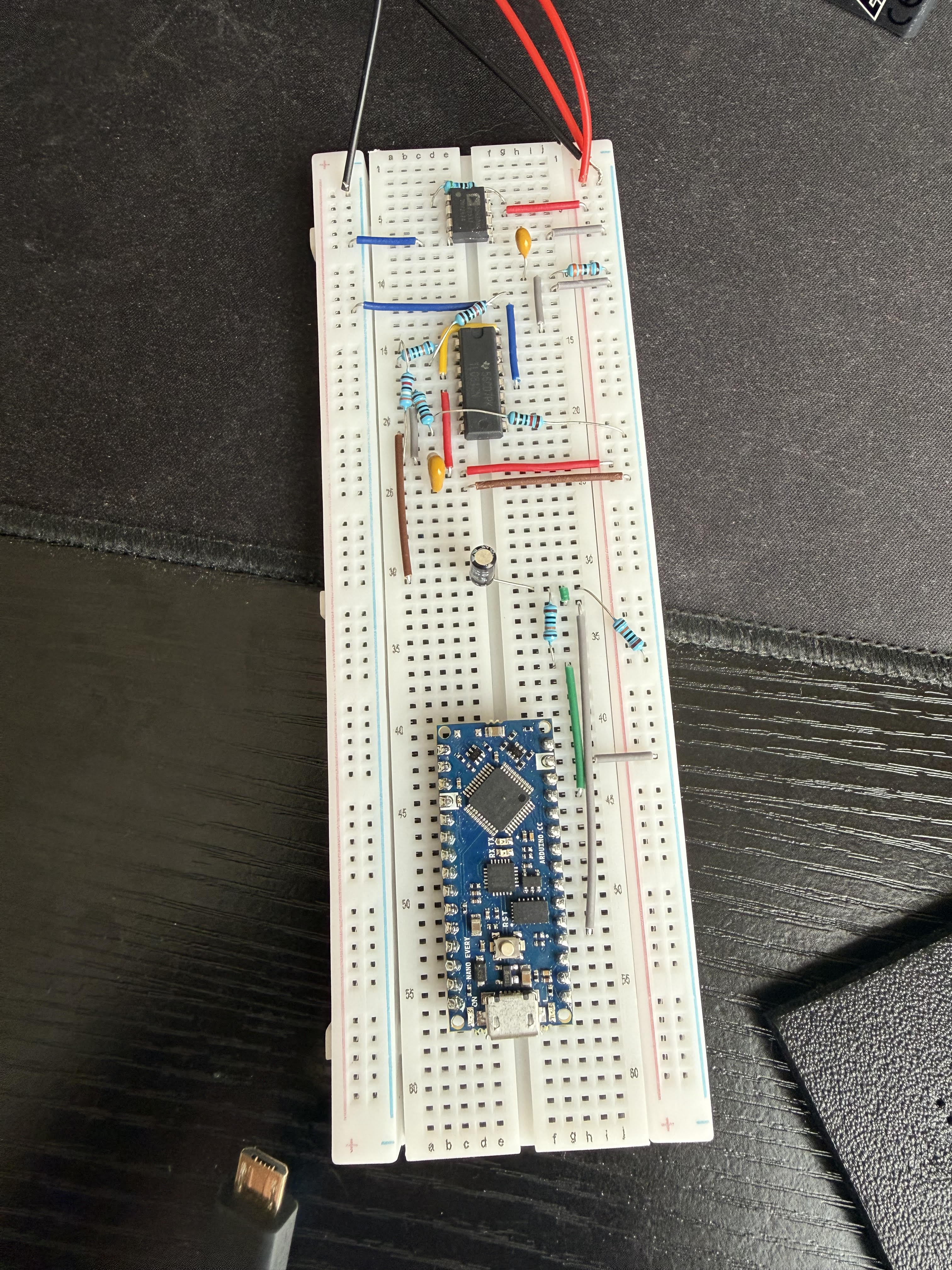Breadboard circuit using an AD620 instrumentation amplifier and analog components to filter and amplify biosignals